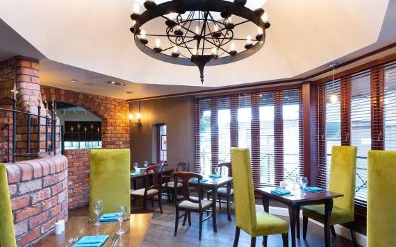 Lime green chairs and large windows in Barton Manor's dining area.