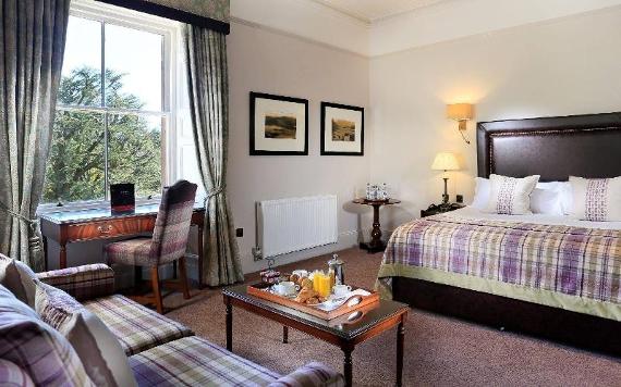 Macdonald Tickled Trout double bed hotel room with check sofa and desk.