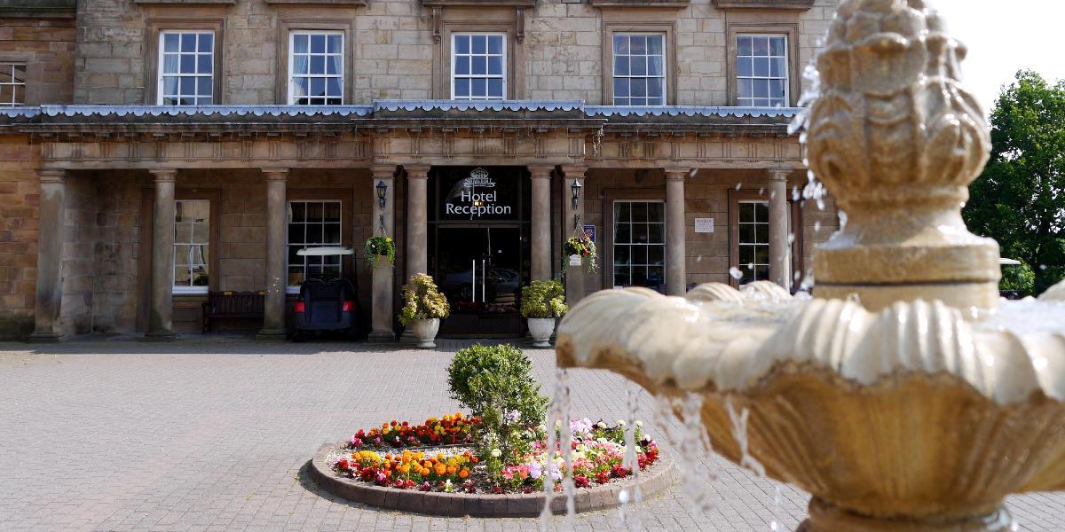 Entrance to Shaw Hill Hotel with fountain in foreground.