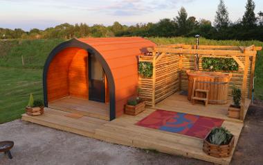 A camping pod at Stanley Villa Farm with an wood fired hot tub next to it