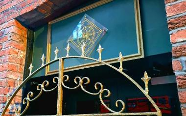 Golden gates outside Florianas restaurant window.