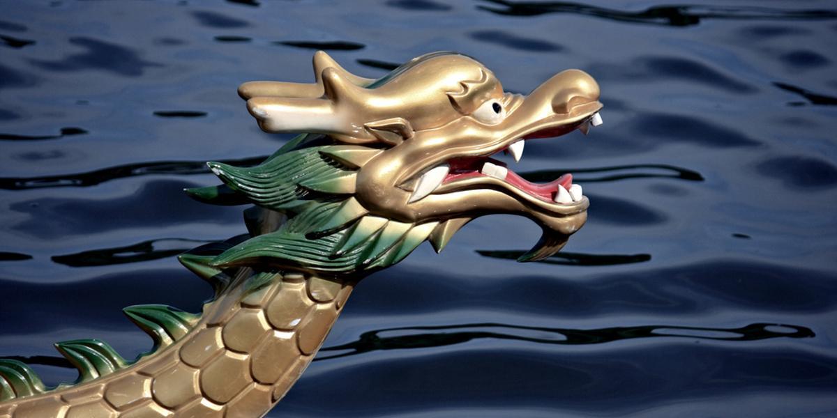 Head of dragon boat with carved dragon head.