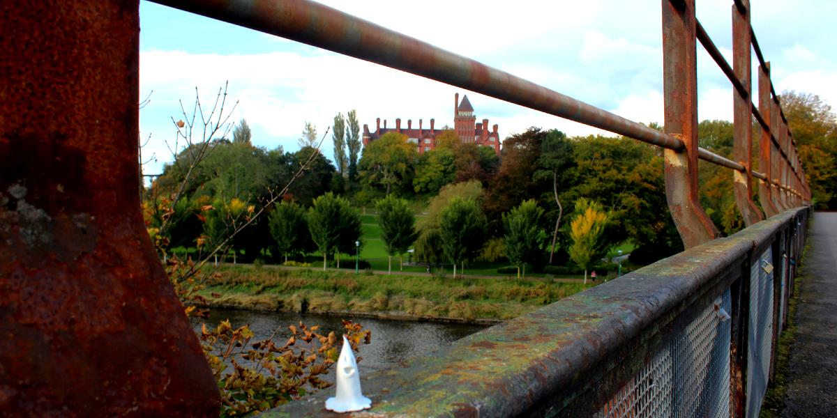 Small ghost figurine on bridge overlooking Miller Park on Autumn day