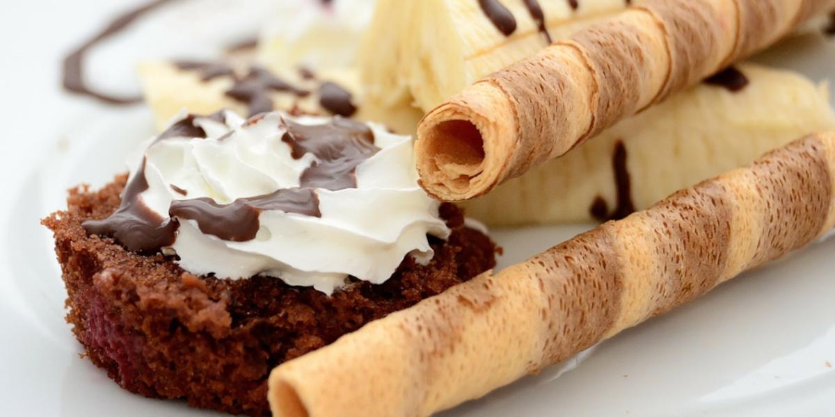 Close up of banana and chocolate dessert with wafers.