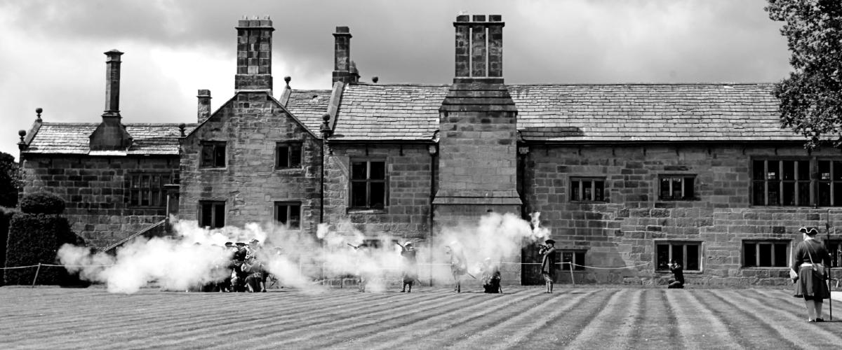 Black and white reenactment of 1715 Battle of Preston at Hoghton Tower.